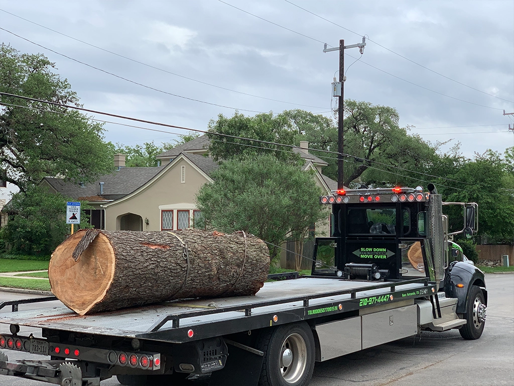 14-foot dump trailer and 32-foot flatbed for log transport