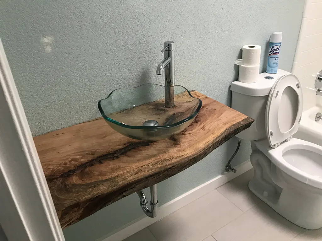 Live edge wood vanity top with glass vessel sink by Green Wood Milling Co.