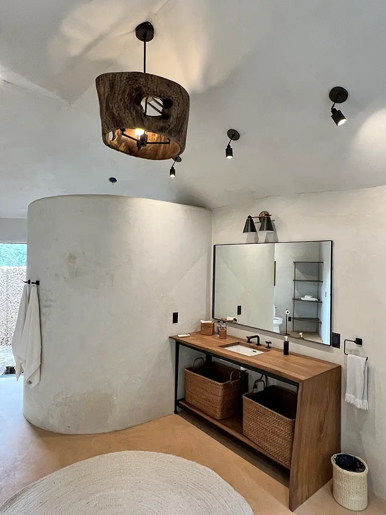 Custom wood vanity with carved wood pendant light in luxury bathroom