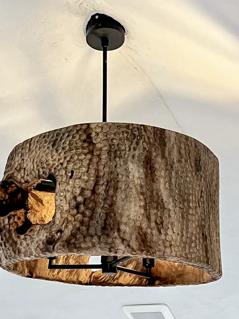 Hand-carved wood pendant light fixture close-up by Green Wood Milling Co.
