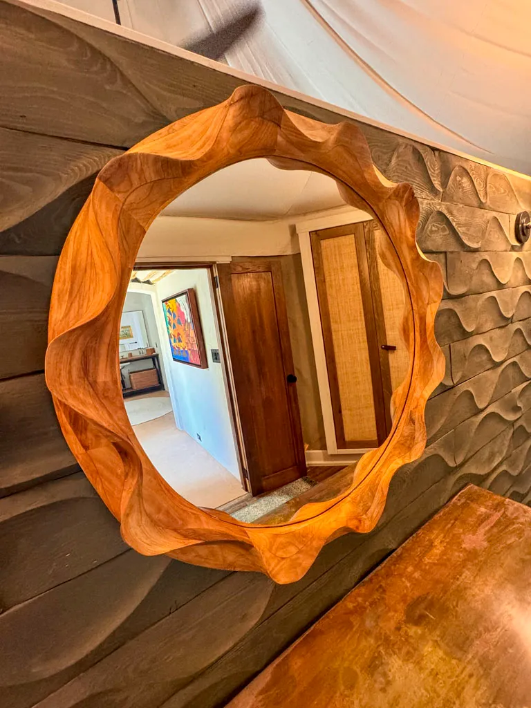 Hand-carved round wood mirror by Green Wood Milling Co.