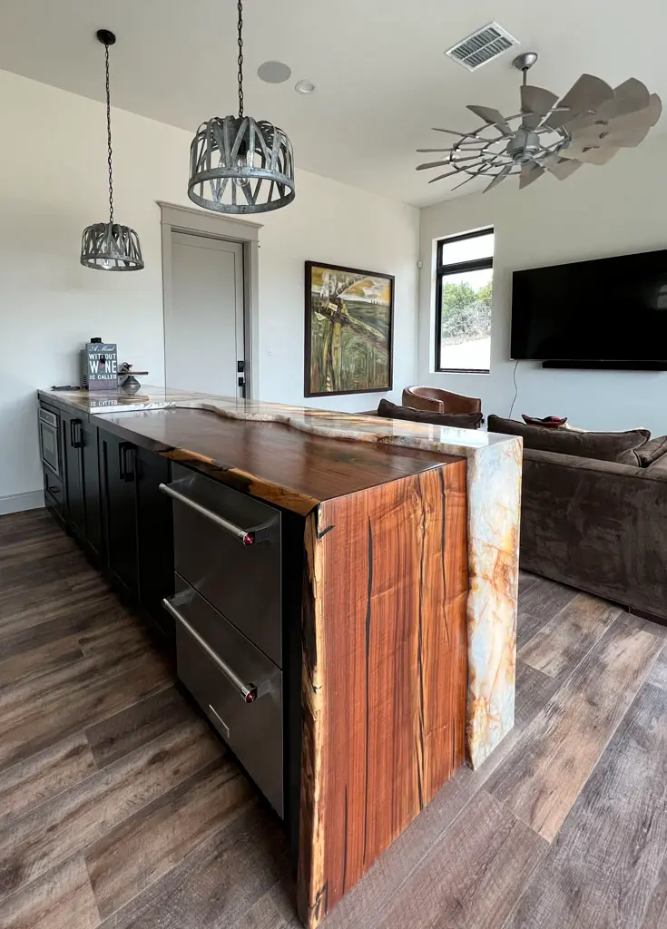 Handcrafted live edge kitchen island with marble waterfall end panel