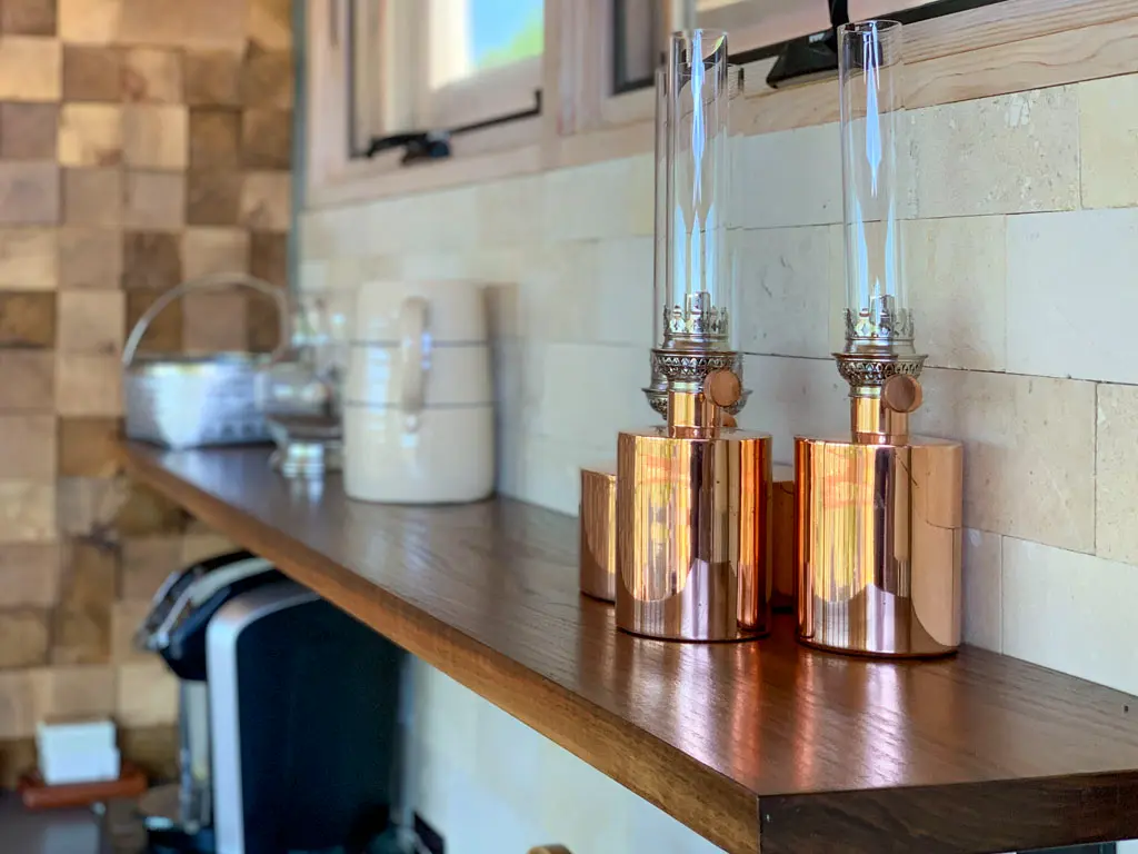 Handcrafted floating shelf with copper oil lamp accents