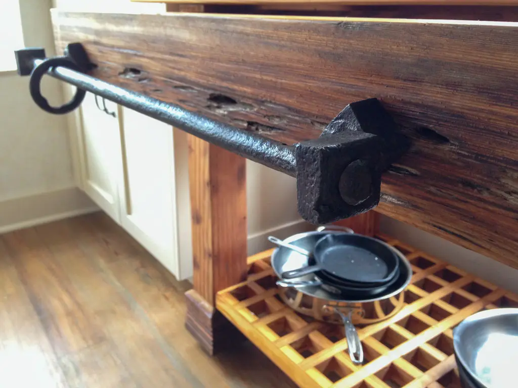 Reclaimed wood kitchen prep table with wrought iron towel bar detail