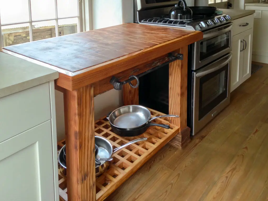 Custom reclaimed wood kitchen island with lattice shelf and iron hardware