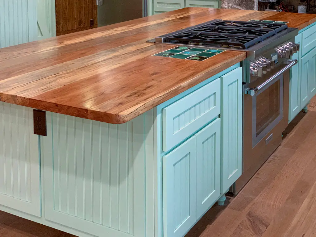 Custom butcher block countertop on mint green kitchen island