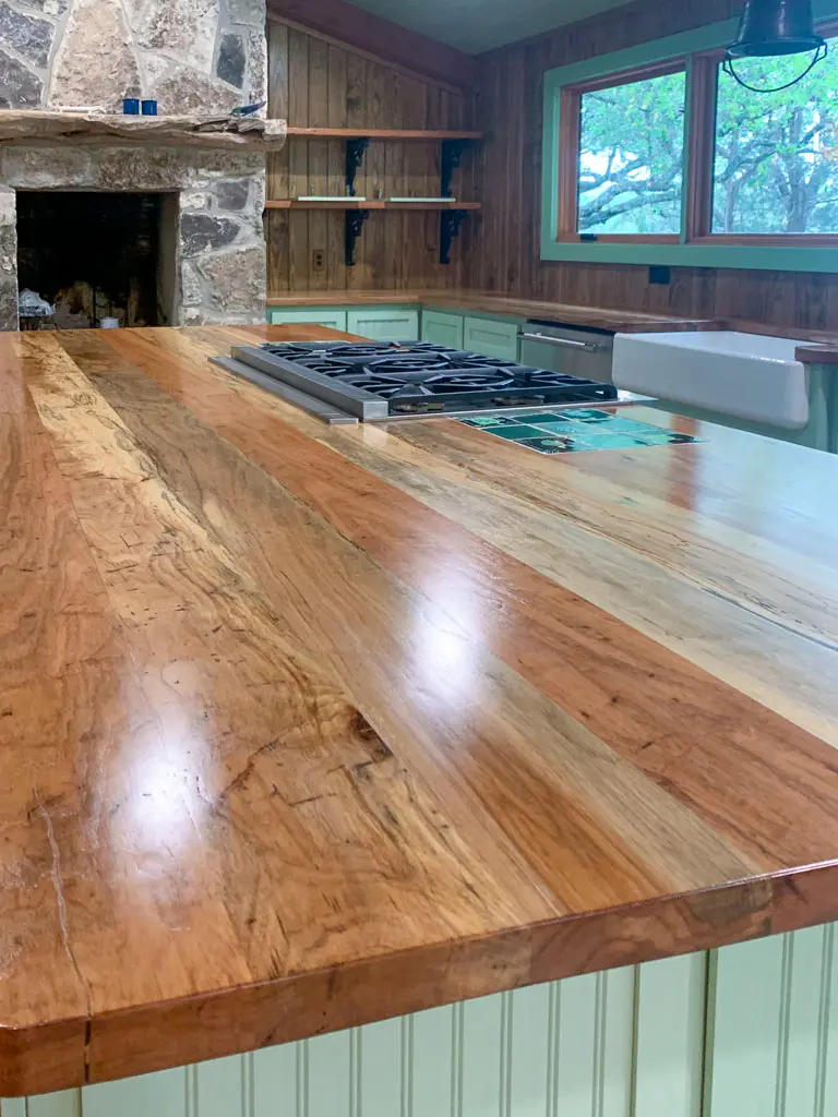Custom spalted wood kitchen countertop with built-in gas cooktop