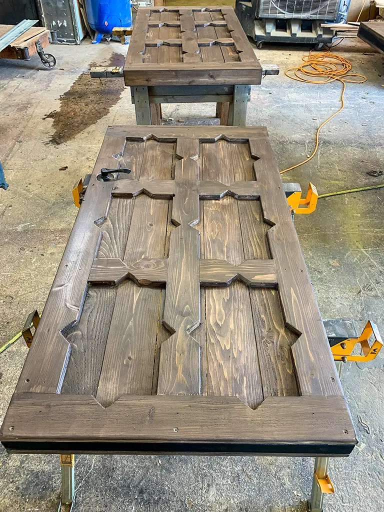 Custom wooden entry doors with raised geometric panel trim, hand-crafted by Green Wood Milling Co in San Antonio, TX
