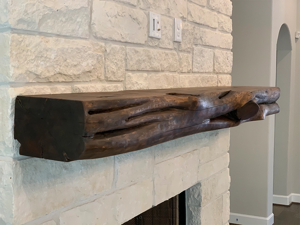 Distressed wood beams and fireplace mantles in rustic interior