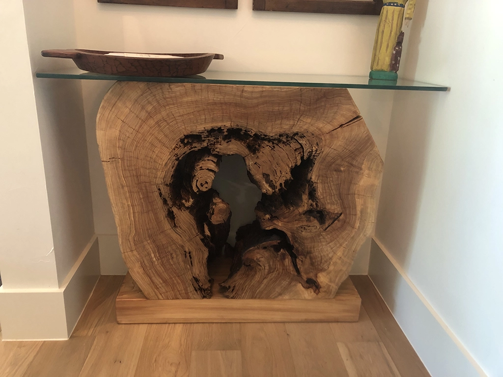 Custom live edge slab console table with glass top in San Antonio home