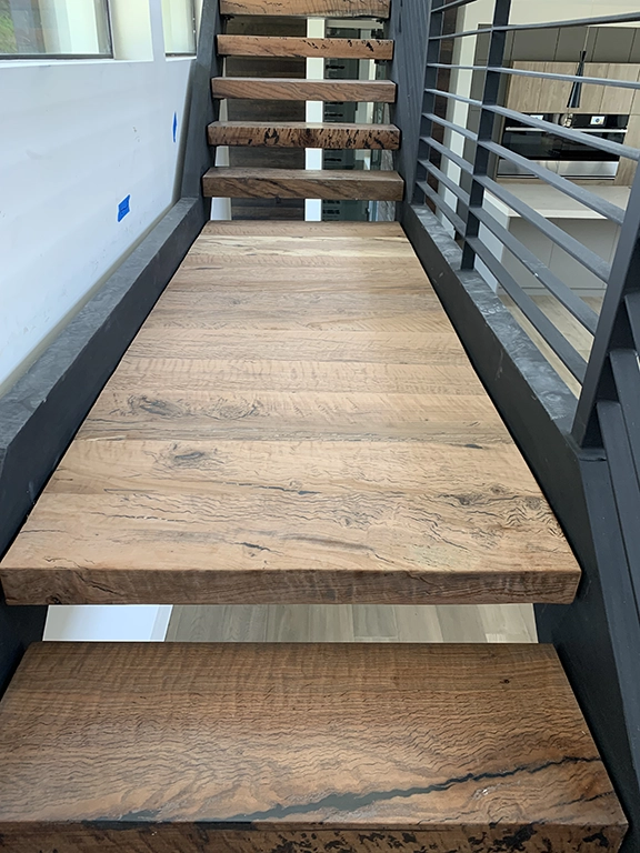 Custom floating wood stair treads with metal railing