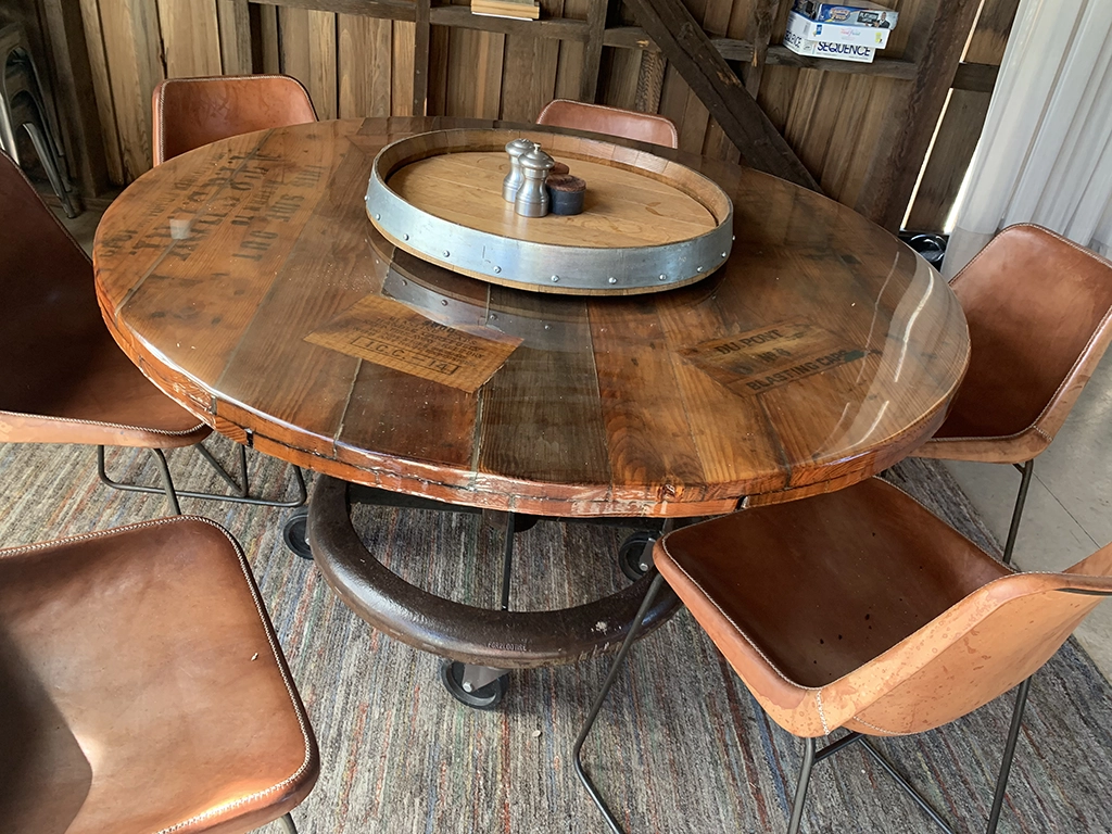 Round reclaimed wood dining table with lazy susan centerpiece