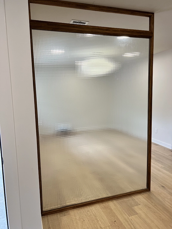 Custom wood-framed textured glass room divider