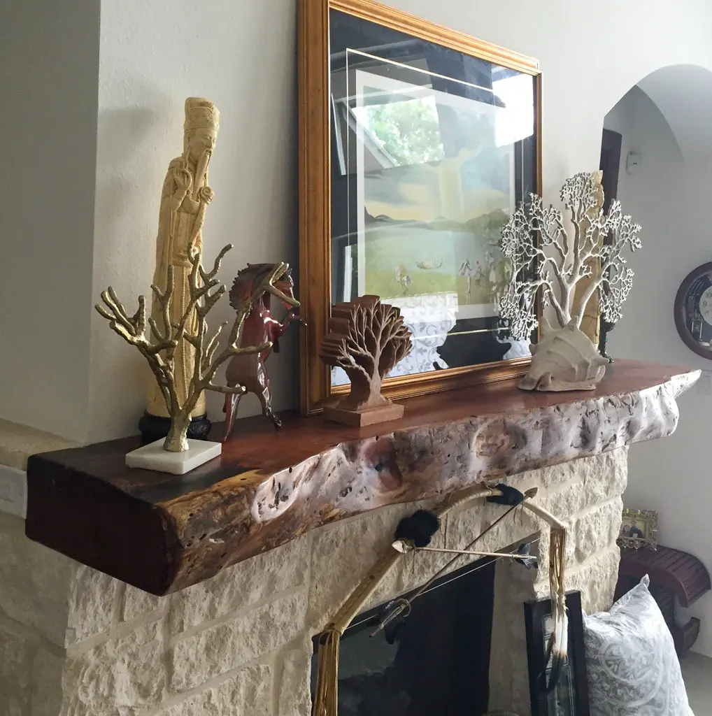 Live edge wood mantle on stone fireplace by Green Wood Milling Co. in San Antonio