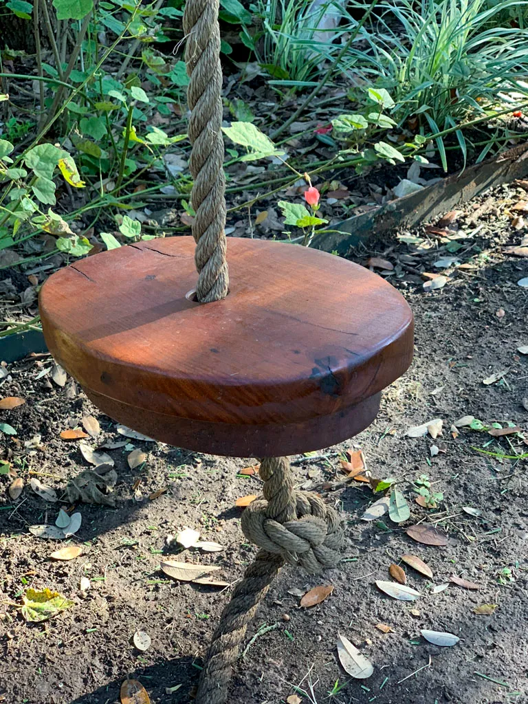 Handcrafted wooden rope tree swing in San Antonio backyard