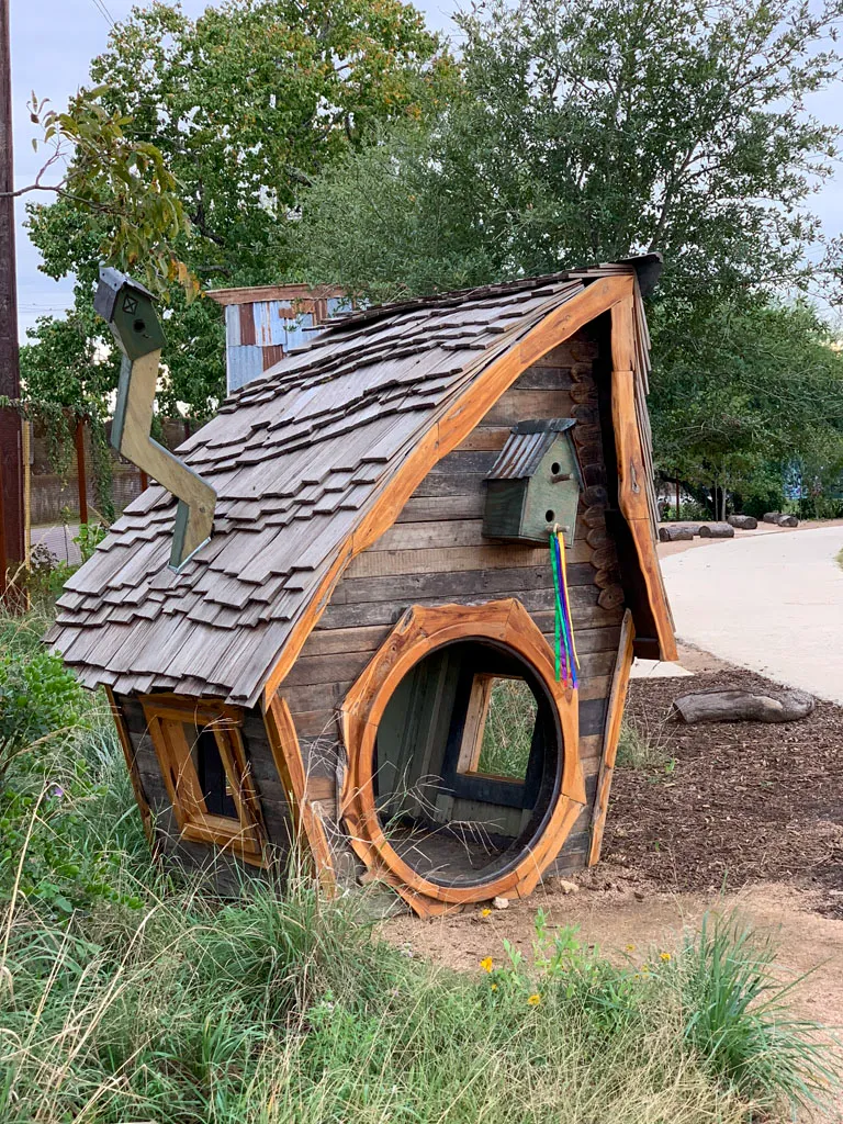 Custom whimsical wooden playhouse with round portal window