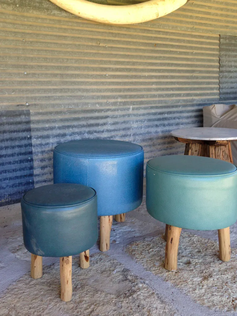Upholstered round stools with natural wood legs for outdoor seating