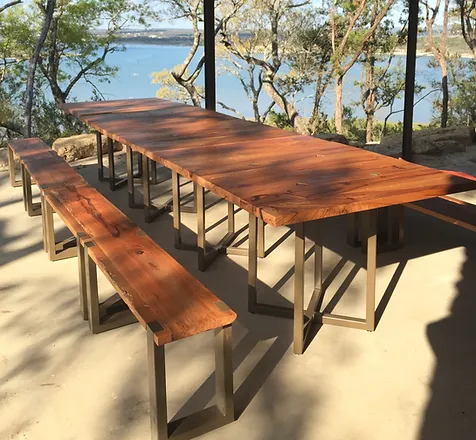 Reclaimed wood outdoor dining table and bench set with steel frame, lakeside Texas setting