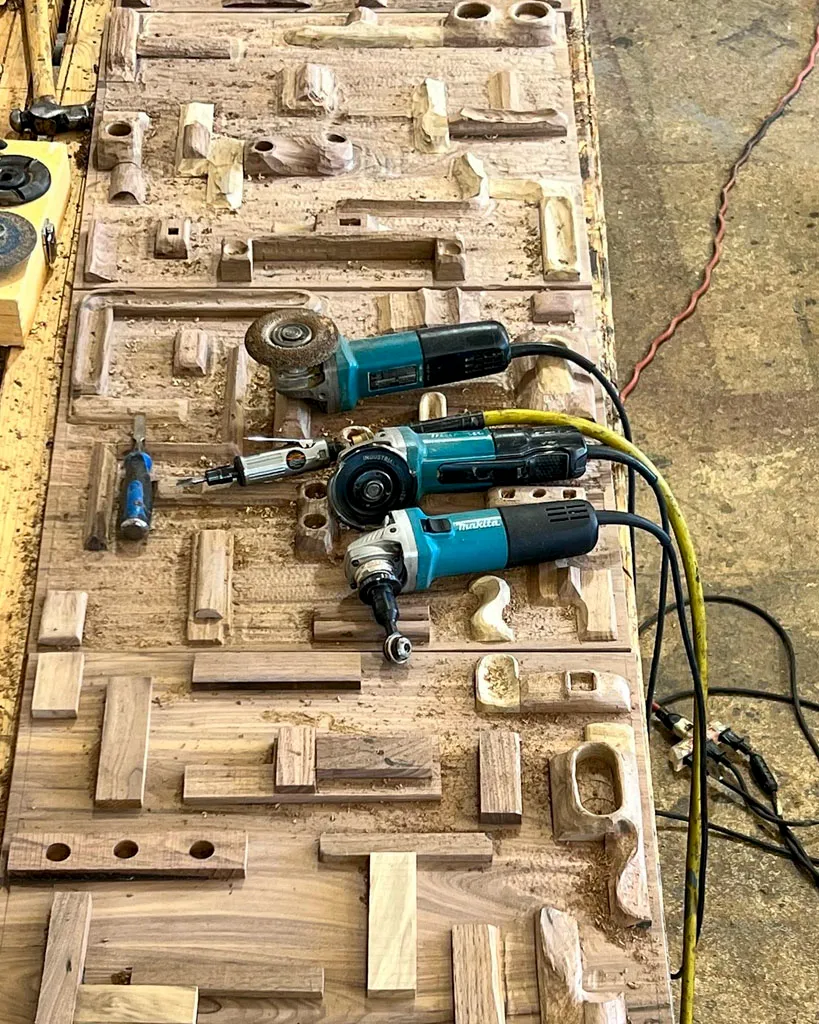 Carved wood relief panel in progress on workbench in San Antonio