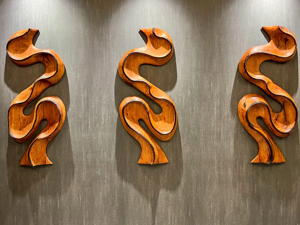 Abstract flowing wood wall sculptures with dark finish in San Antonio