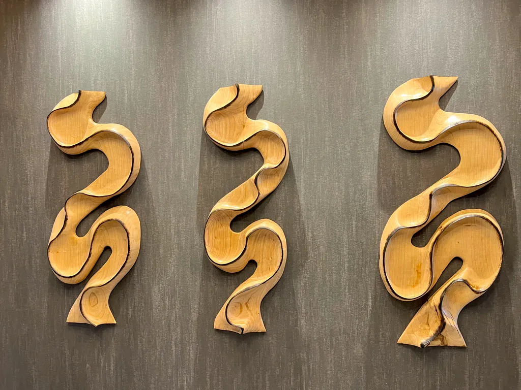 Abstract flowing wood wall sculptures with light finish in San Antonio