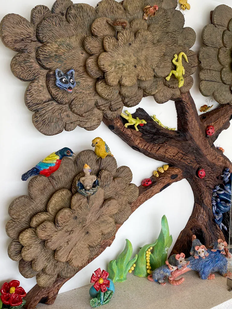 Carved tree wall mural with animals by Green Wood Milling Co.